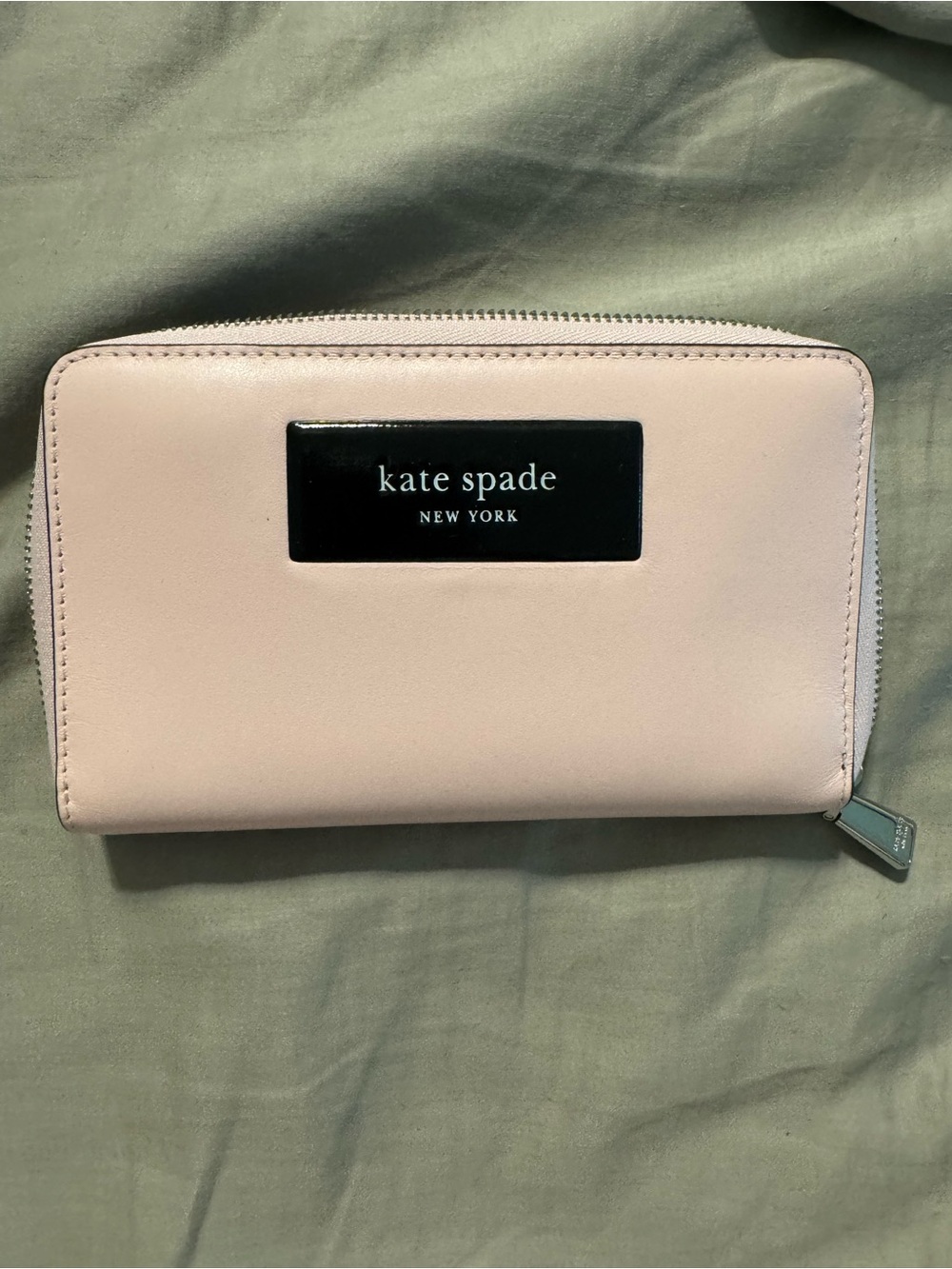 kate spade pale pink zip-around wallet with logo plaque